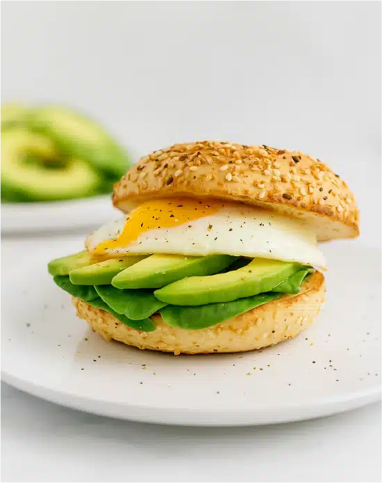 Served sliced cottage cheese bagel with toppings