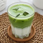 served matcha protein latte with cinnamon and spoon