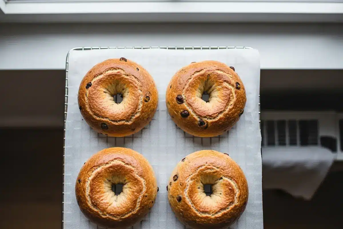 Gluten-free protein bagels on cooling rack with golden crust