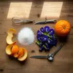 Ingredients for homemade blue curacao syrup on a wooden table