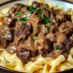 Delicious Beef Stroganoff served over egg noodles in a creamy sauce