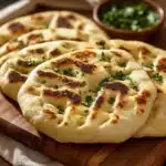 Freshly baked naan bread served with toppings