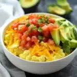 Delicious breakfast burrito bowl filled with eggs, veggies, and salsa.
