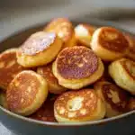 Delicious breakfast pancake poppers served with syrup and fruit