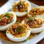 Cajun boiled eggs with spicy garlic butter sauce served as a keto snack