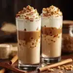 Delicious Cookie Butter Iced Chai Latte served in a clear glass with spices