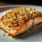 Crispy Parmesan Salmon Bake garnished with herbs on a serving plate.