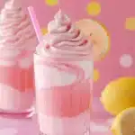 Delicious whipped pink lemonade in a glass with a slice of lemon