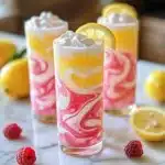 Refreshing whipped pink lemonade drink topped with whipped cream