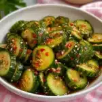 Fresh cucumber salad with herbs and dressing, served in a bowl