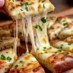 Delicious easy cheesy garlic bread topped with melted cheese and garlic.