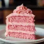Fluffy pink velvet cake topped with creamy frosting for occasions and celebrations