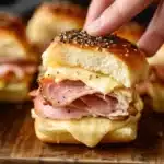 Delicious ham and cheese sliders on a platter, ideal for parties.