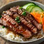 Delicious Korean BBQ steak rice bowl drizzled with spicy cream sauce.