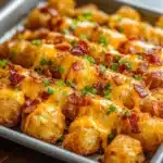 Delicious loaded tater tot skewers topped with cheese and bacon