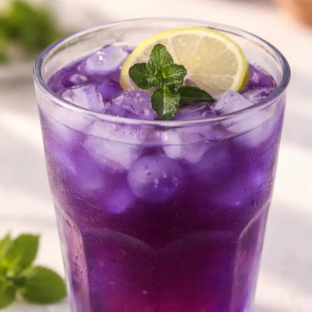 A cup of butterfly pea tea with dried flowers, showcasing its vibrant blue color.