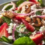 Chicken and strawberry salad with fresh greens and vinaigrette dressing
