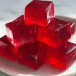 A vibrant healthy gelatin dessert served in a bowl with fresh fruits