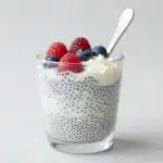 Low sugar Coconut Cream Chia Pudding in a glass topped with fresh fruit