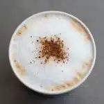 Coconut milk latte served in a cozy morning setting with foam art