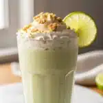 Creamy Coconut Key Lime Pie Smoothie in a glass with lime garnish