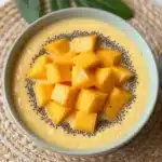 Gluten-free mango chia pudding cups served in clear jars with fresh mango slices