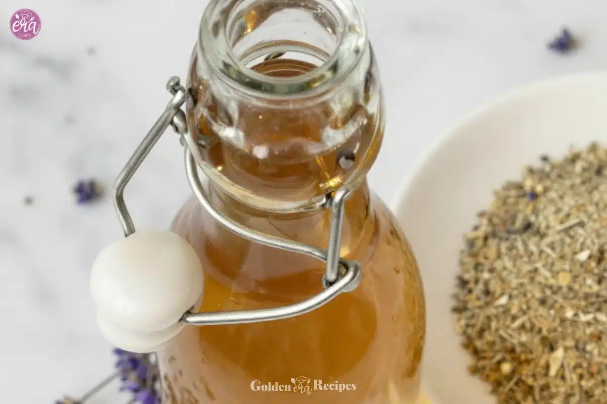 Lavender simple syrup in a glass bottle with fresh lavender sprigs