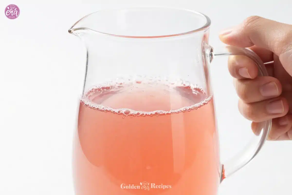Homemade lavender syrup in a glass jar with lavender sprigs