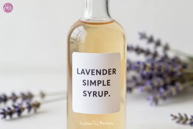 Homemade lavender simple syrup in a glass bottle with lavender flowers
