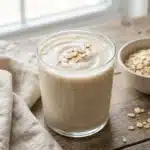 Nourishing oat milk smoothie for weight loss in a glass with fresh fruits.