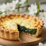 Savoury spring tart with dandelion, fresh ingredients, and vibrant colors on a plate.