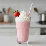 Delicious strawberry protein shake topped with fresh strawberries and mint.