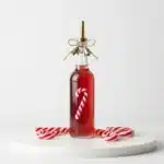 Bottle of homemade candy cane syrup for festive holiday recipes