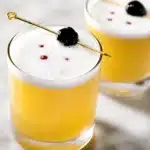 Classic Whiskey Sour cocktail with bourbon, lemon juice, and simple syrup garnished with bitters.