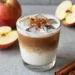 A delicious Apple Crisp Oatmilk Macchiato topped with apple crumble and caramel.