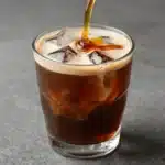 Delicious caramel iced coffee in a glass with ice and whipped cream