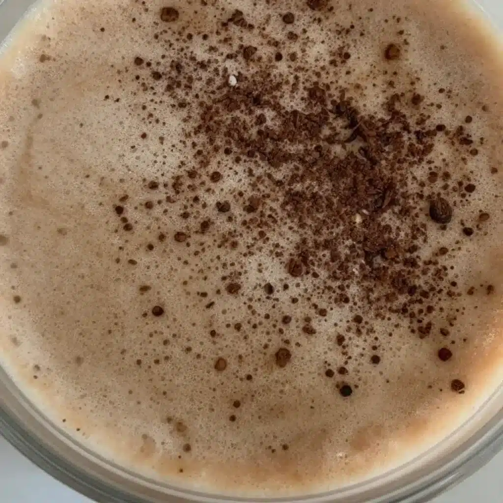 Coffee Protein Smoothie Gentle Embrace 5 Coffee Protein Smoothie Gentle Embrace in a glass with coffee beans and protein powder.