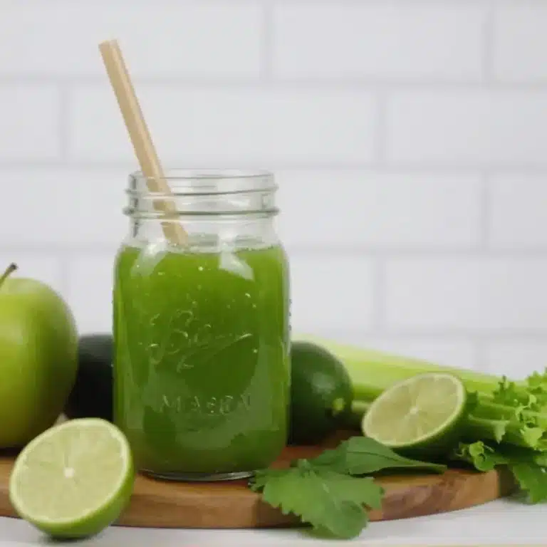 Fresh green juice in a glass with fruits and vegetables for beginners