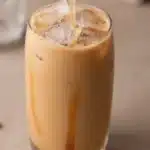 Homemade iced caramel coffee in a glass with whipped cream