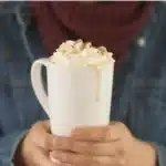 Delicious Maple Pecan Latte with whipped cream and pecans on top.