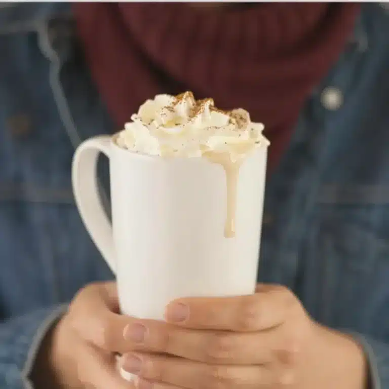 Delicious Maple Pecan Latte with whipped cream and pecans on top.
