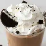 Delicious Oreo iced coffee topped with whipped cream and cookie crumbles