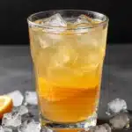 A colorful Pineapple Passionfruit Refresher drink garnished with fruit slices.