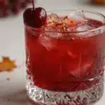 Red Witch Mocktail Velvet Evening - a vibrant, non-alcoholic drink featuring rich red hues.
