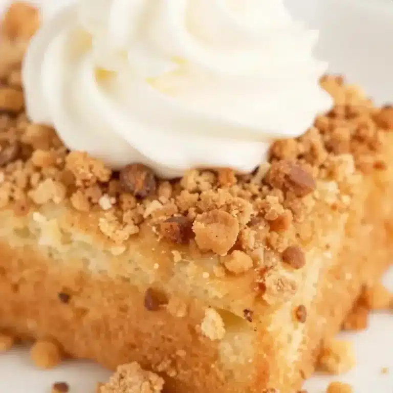 Delicious pumpkin dump cake topped with whipped cream and fall spices