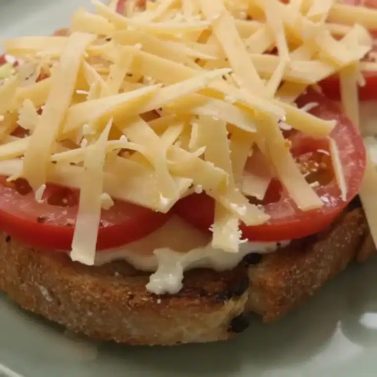 Delicious Tomato Toast garnished with fresh herbs and served on crispy bread.